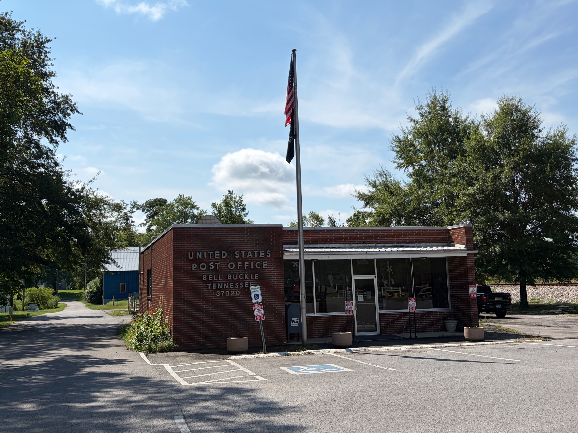 Small brick United States Post Office for Bell Buckle, Tennessee, with a flag flying outside